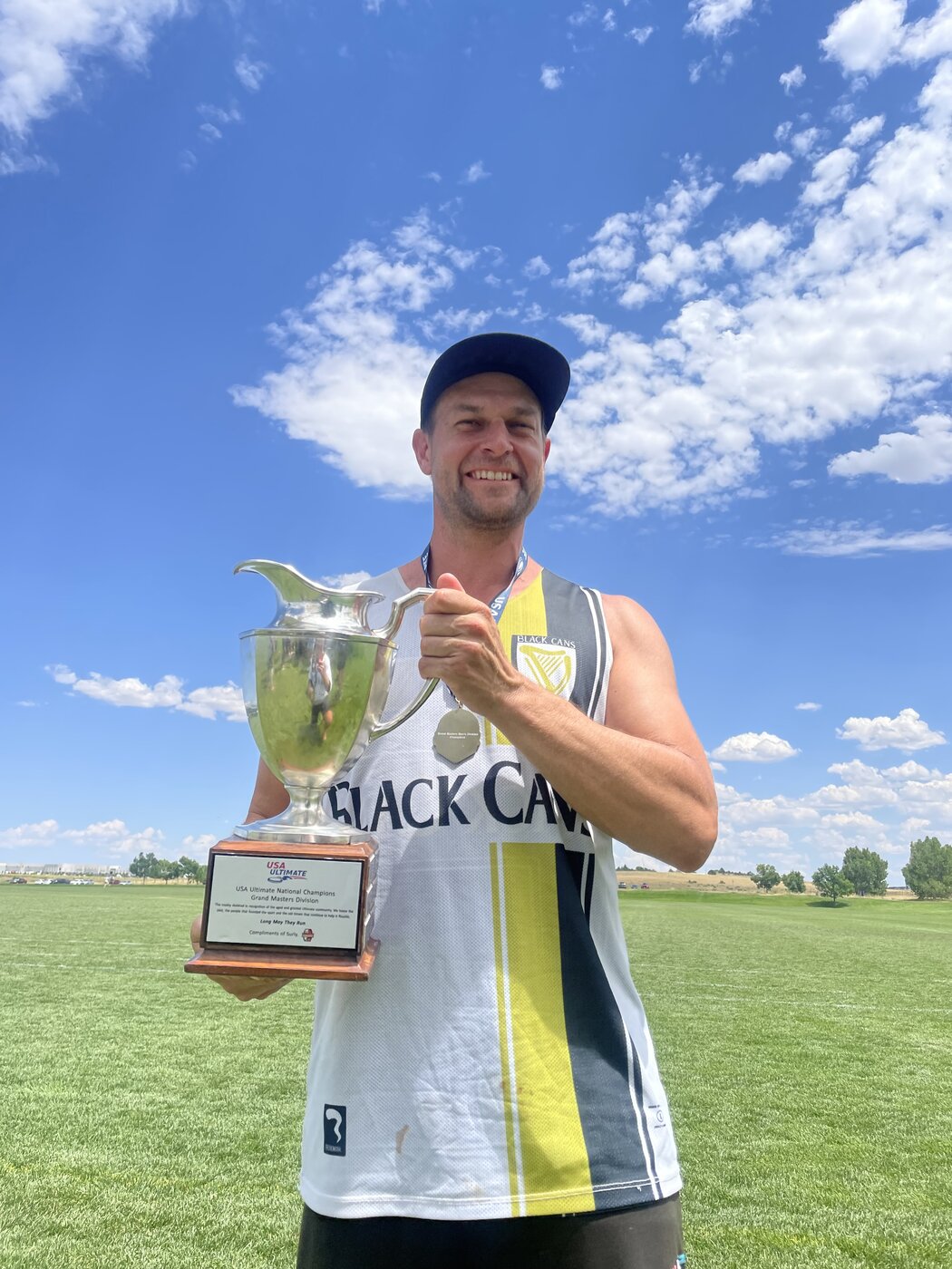Holding the USA Ultimate Grand Masters national championship trophy in a Black Cans jersey